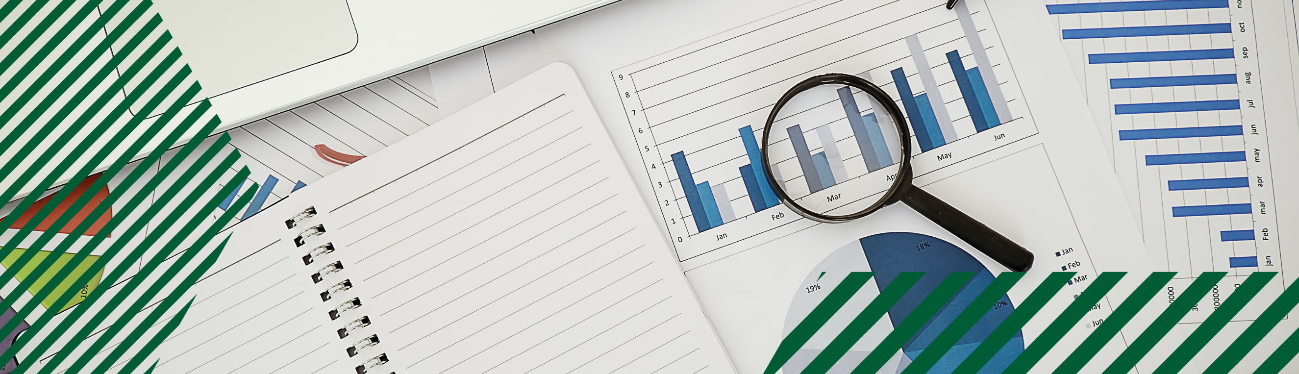 A magnifying glass resting on top of a pile of charts.